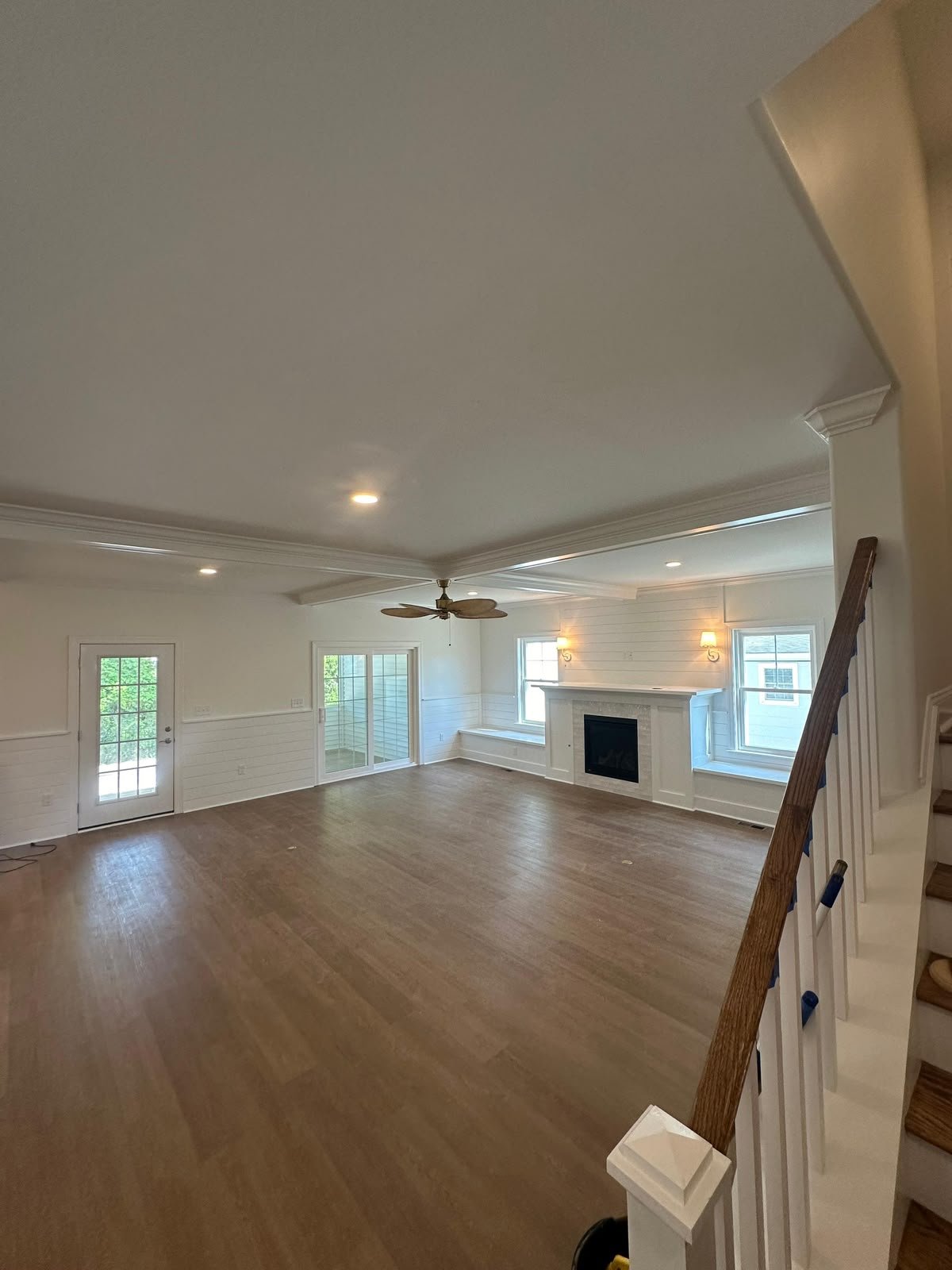 Completed great room with finished ceiling, walls, and fireplace